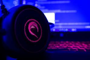 Soundboard and headphones illuminated by neon lights during a live podcast session