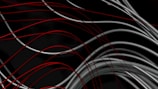 Abstract metallic lines intersecting over a dark background with deep red highlights.