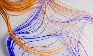 a bunch of orange and blue wires on a white surface