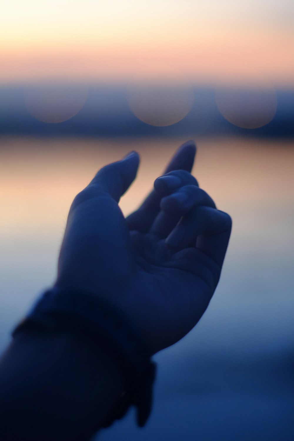 a person holding their hand up to the sky