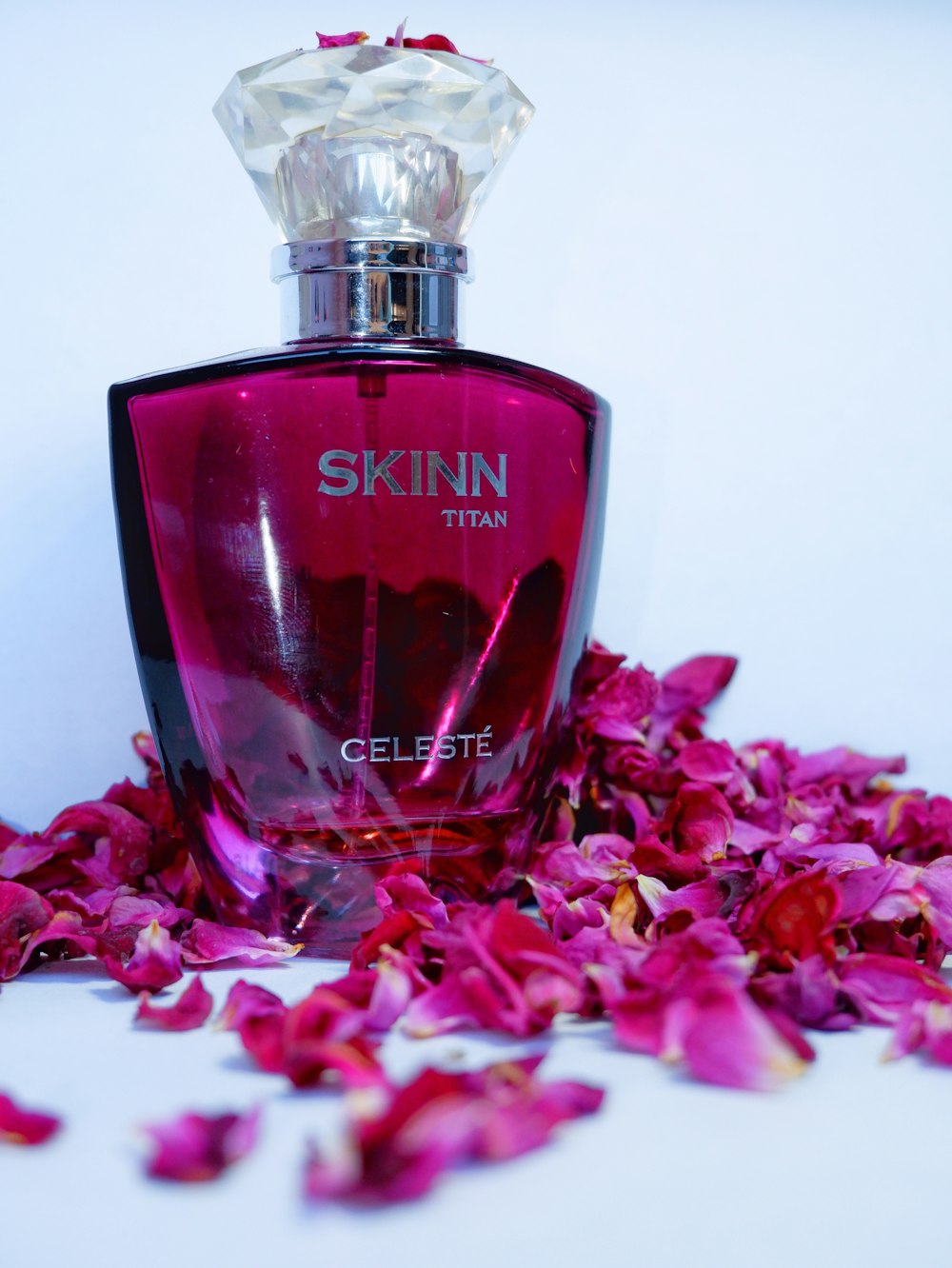 a bottle of skin titan gelette surrounded by flowers
