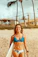Smiling Brazilian woman enjoying a tropical beach vacation