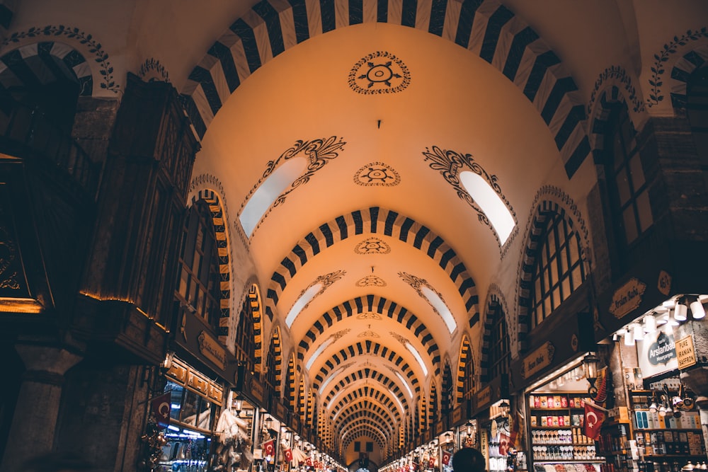 the inside of a large building with a clock on the ceiling