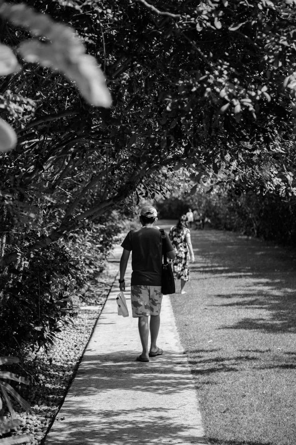 a man and a woman walking down a sidewalk