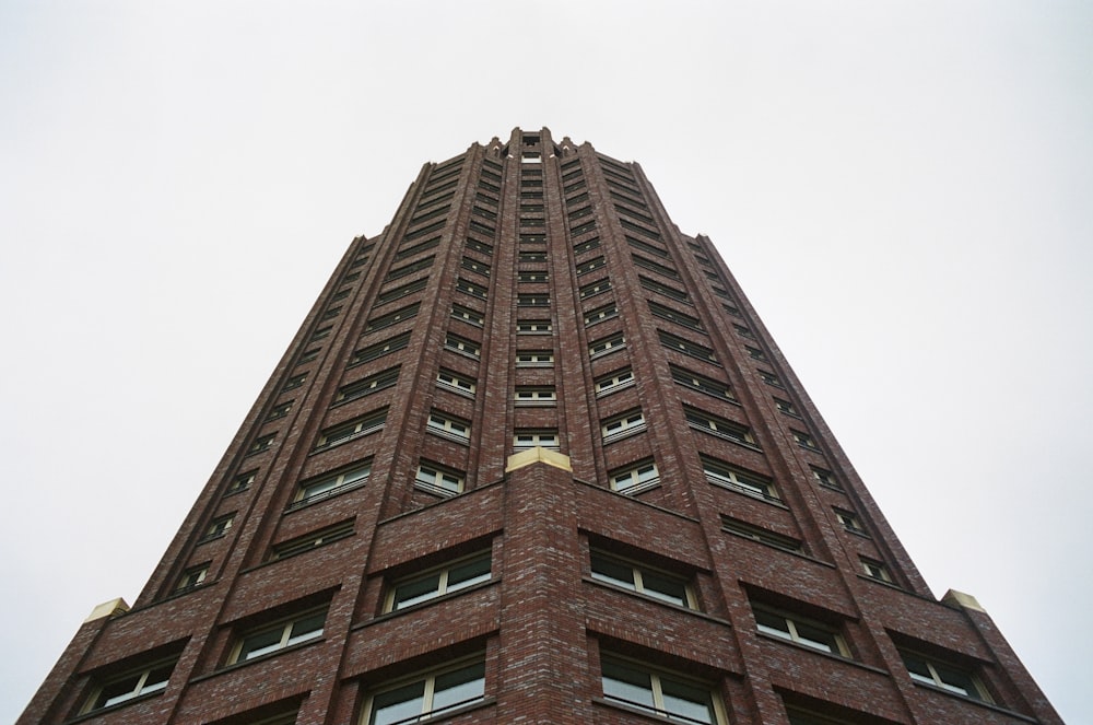 a tall brick building with a sky background