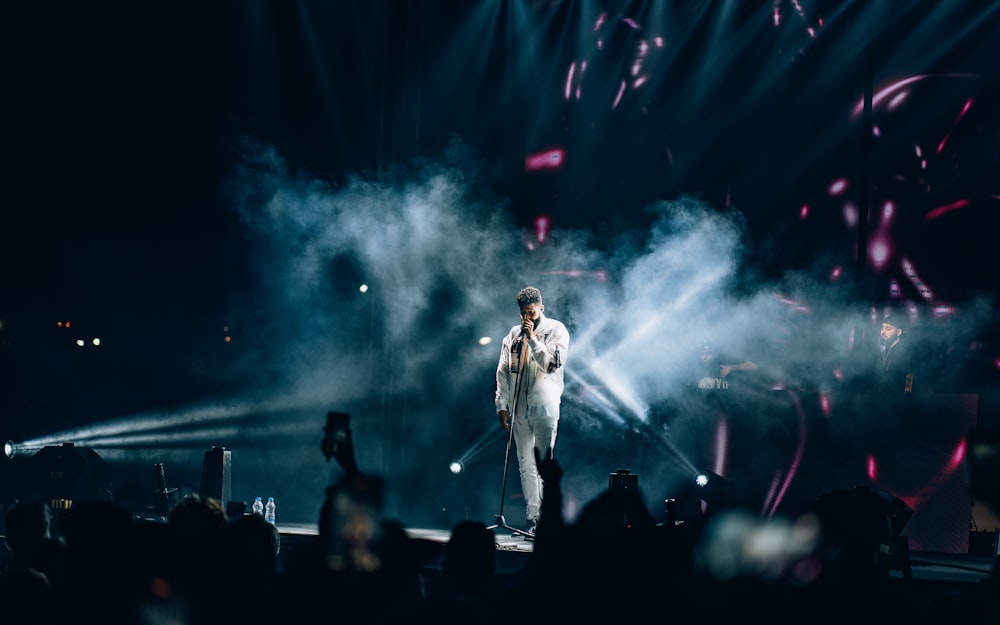 a man standing on a stage in front of a crowd