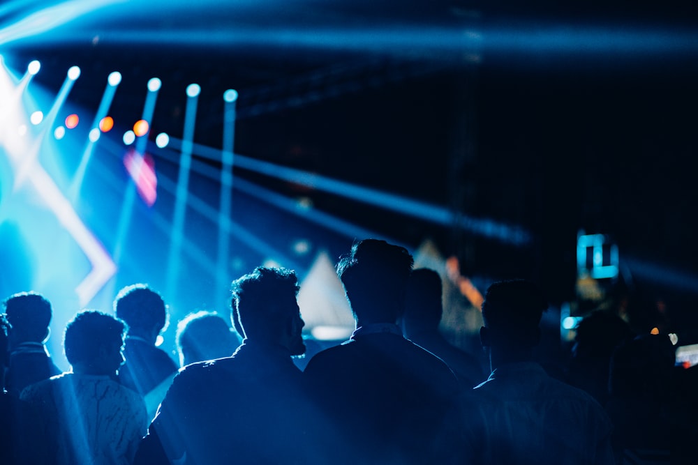 a group of people standing in front of a stage