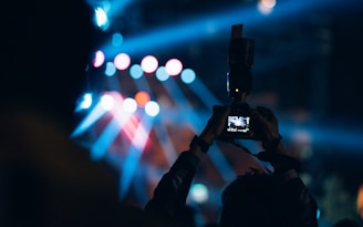 a person taking a picture with a cell phone