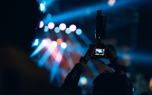 a person taking a picture with a cell phone