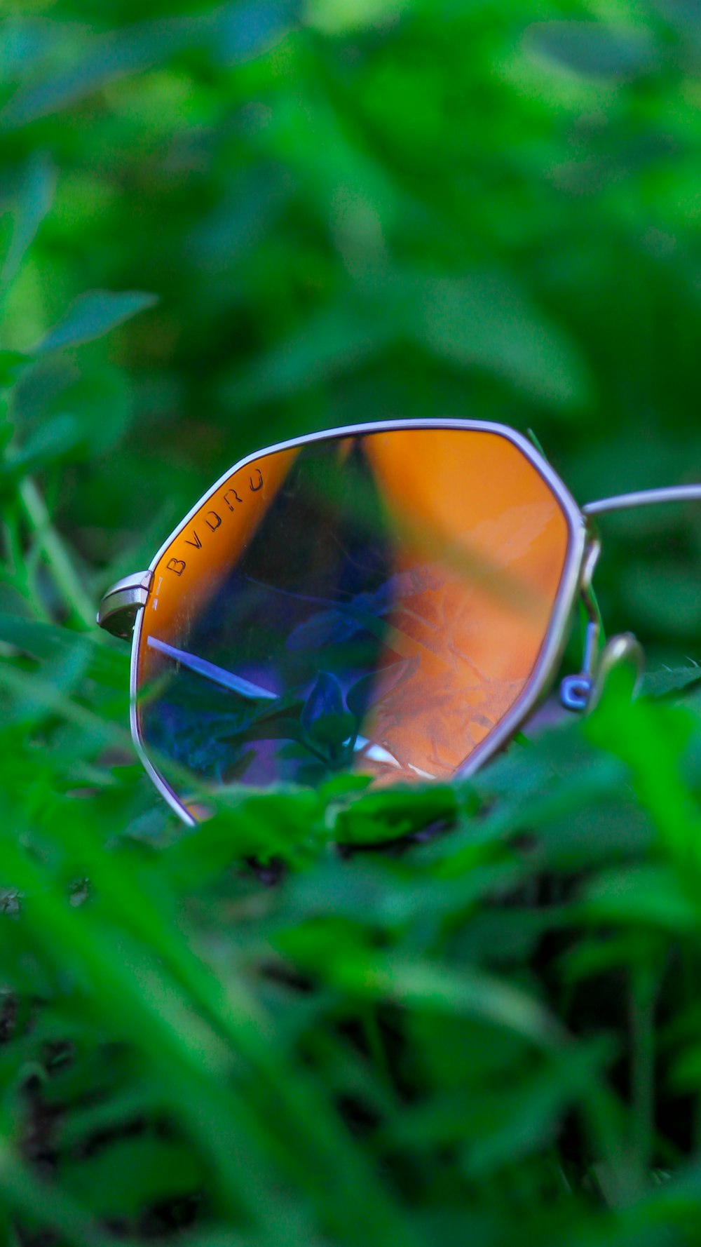 a pair of sunglasses laying in the grass