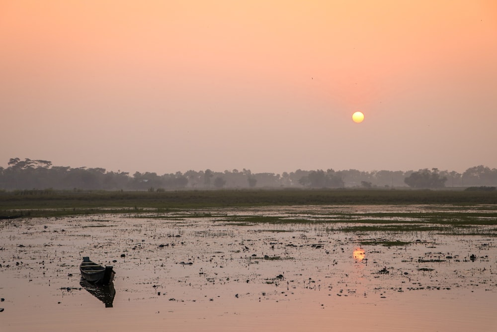 a small boat floating on top of a body of water