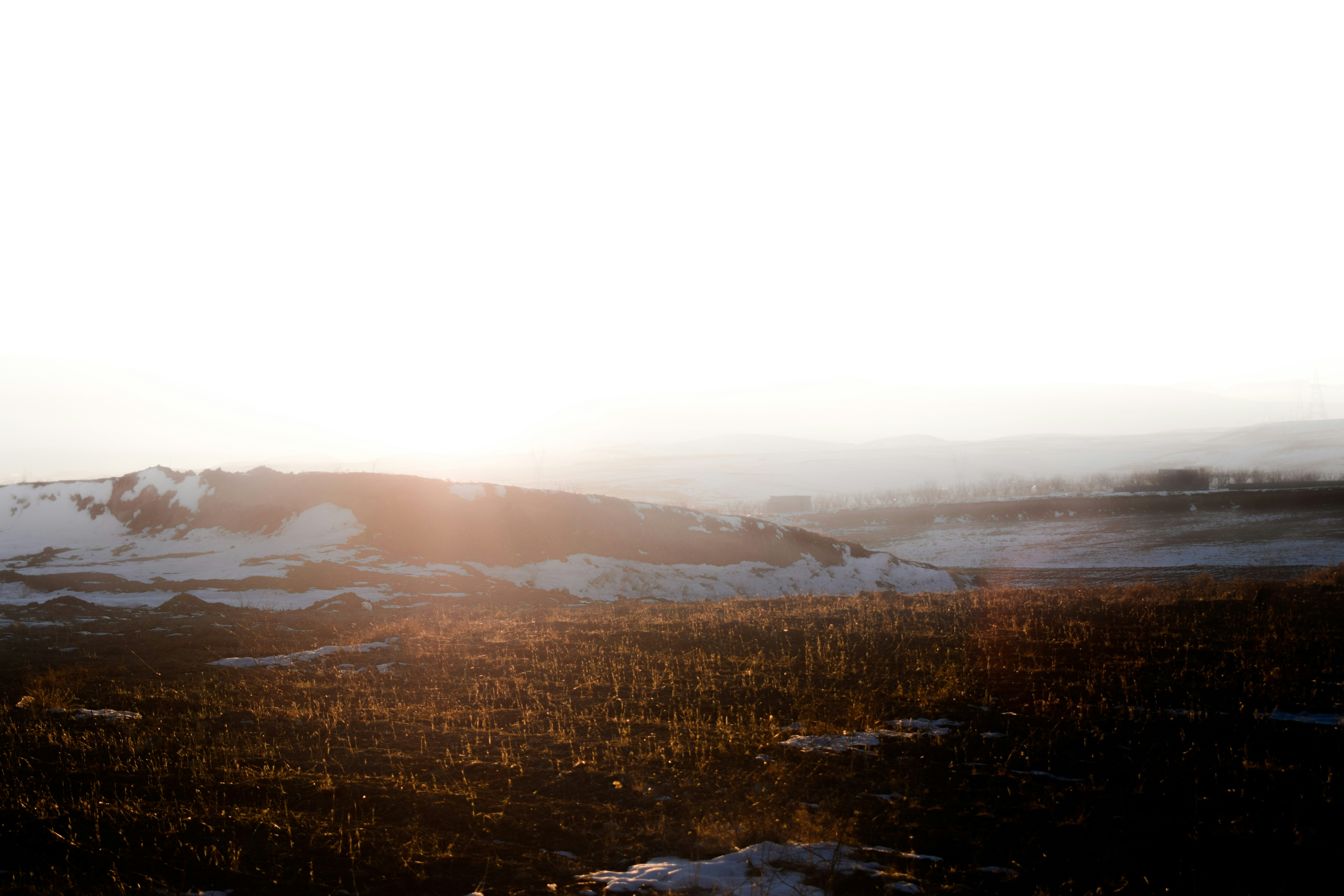 the sun is shining on a snowy mountain