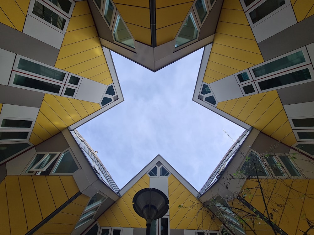 a view looking up at a yellow and white building