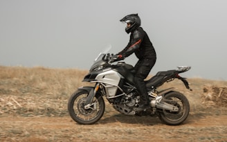 a person riding a motorcycle on a dirt road
