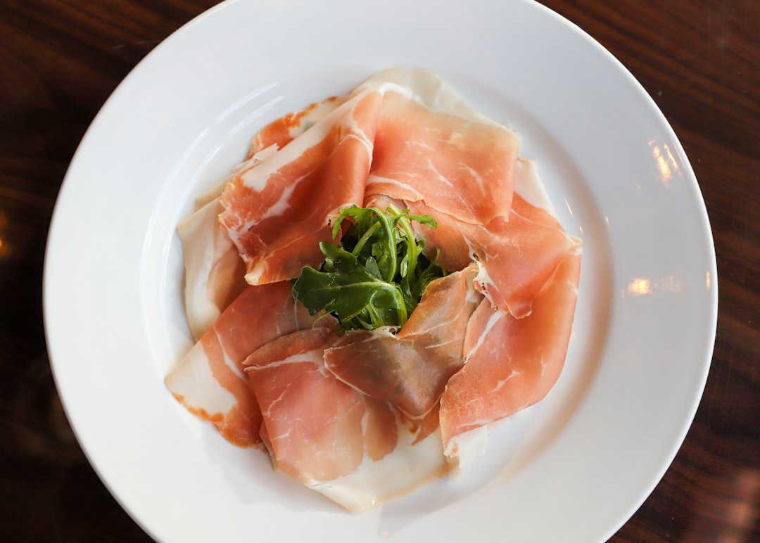 a white plate topped with meat and veggies, Prosciutto Small Plate
