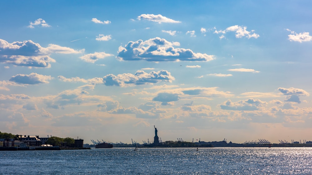 a large body of water with a city in the background