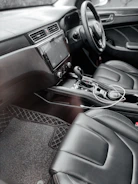 the interior of a car with black leather seats