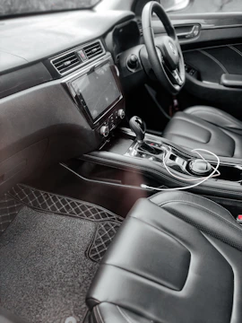 the interior of a car with black leather seats
