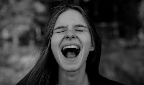 Close-up of a laughing person reacting to a prank.