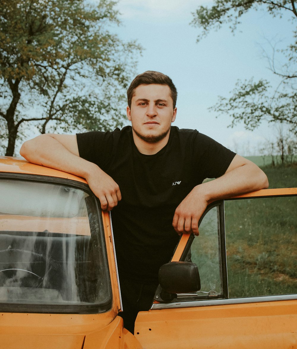 a man leaning on the hood of a truck