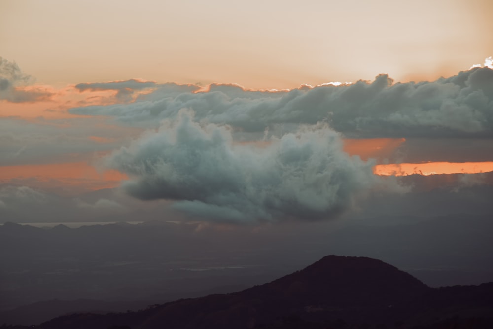 the sun is setting over a mountain range