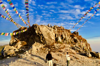 A colorful collage of travelers enjoying diverse pilgrimage sites and scenic landscapes under a magenta sky.