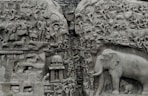 a stone carving of elephants and other animals