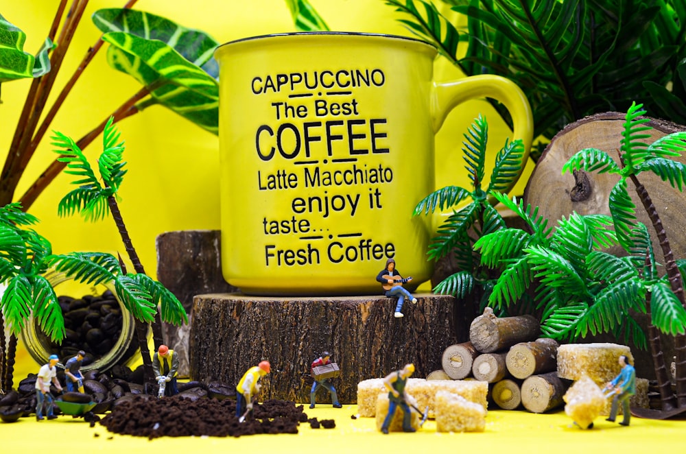 a yellow coffee mug sitting on top of a tree stump