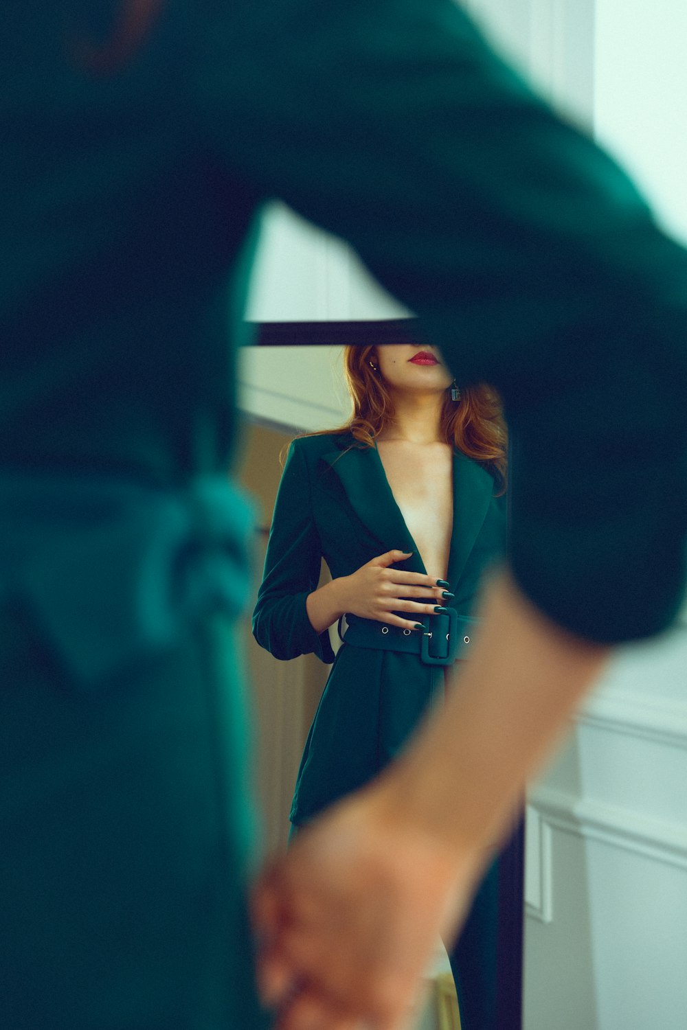 a woman standing in front of a mirror