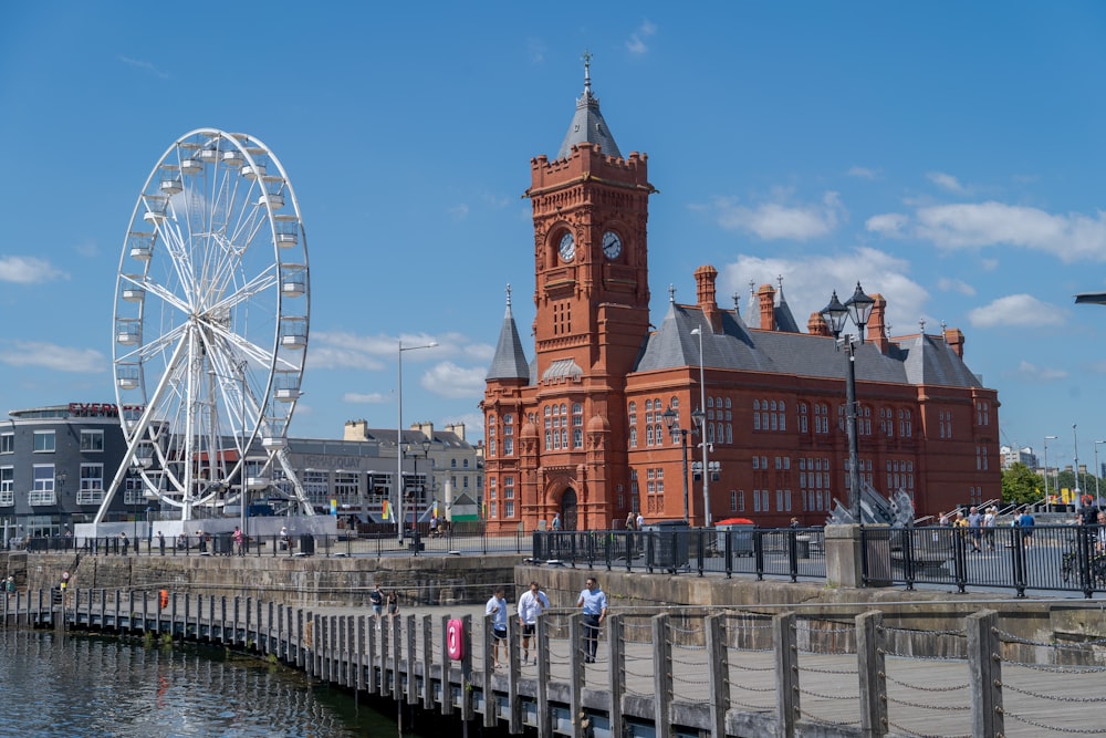 a large building with a ferris wheel in front of it