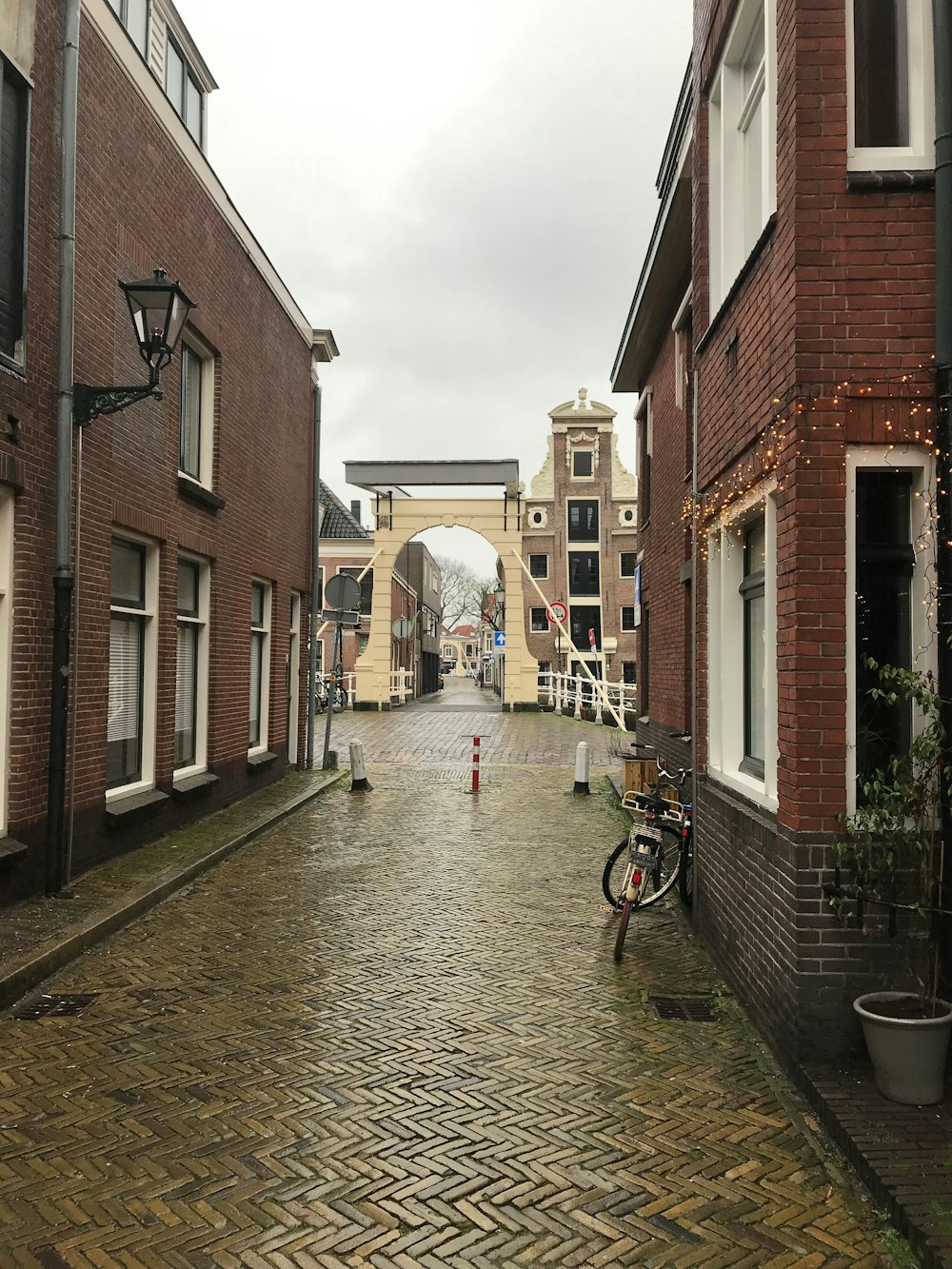 a cobblestone street lined with brick buildings