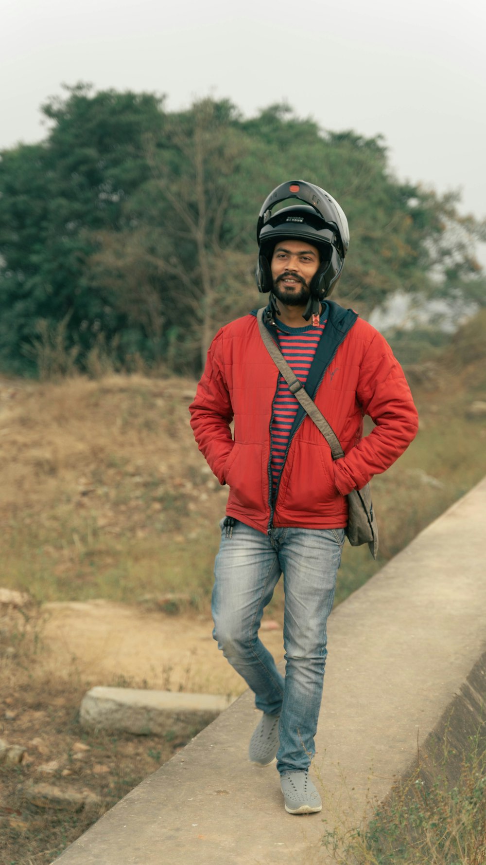 a man wearing a helmet and a red jacket