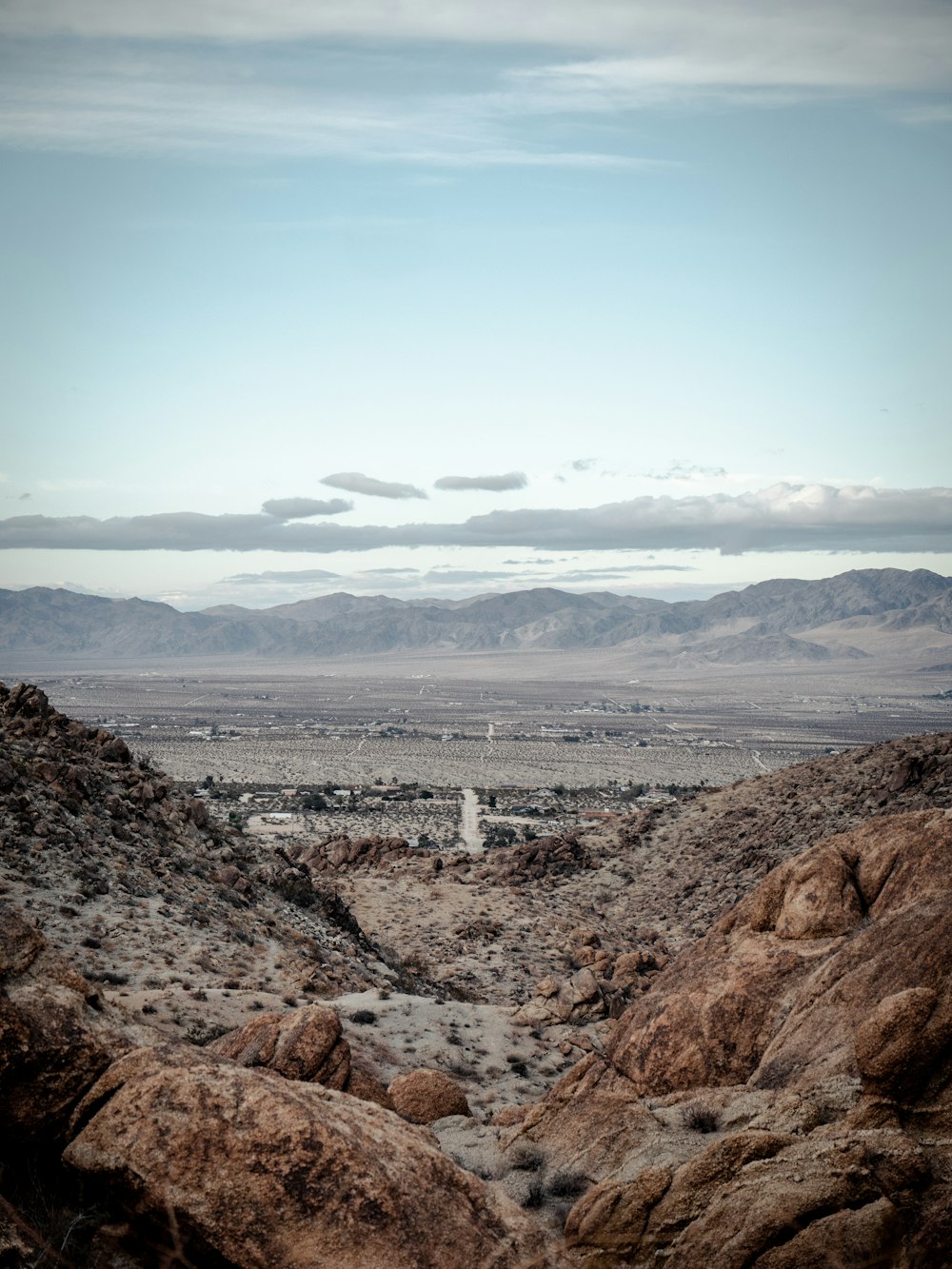 a view of a desert with mountains in the distance