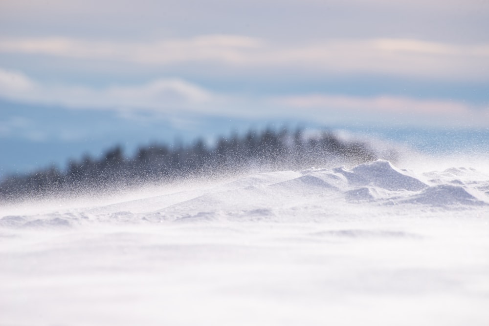 a person riding a snowboard down a snow covered slope