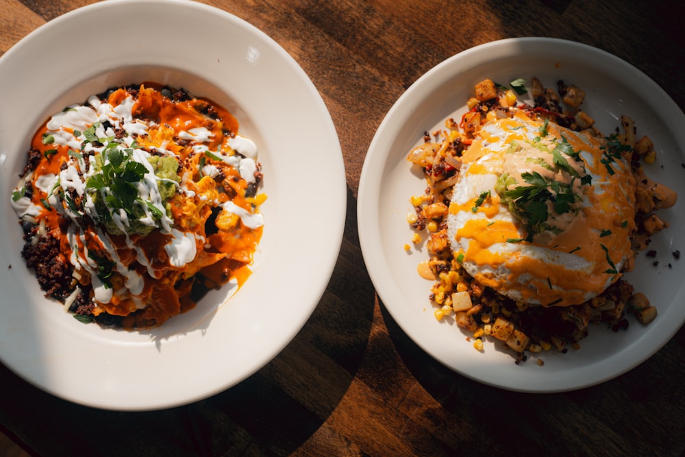 two plates of food on a wooden table