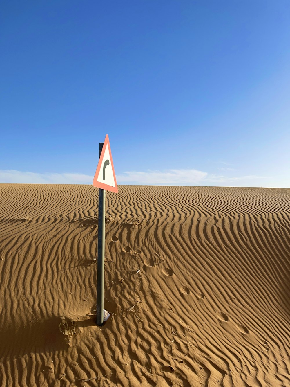 a road sign in the middle of a desert