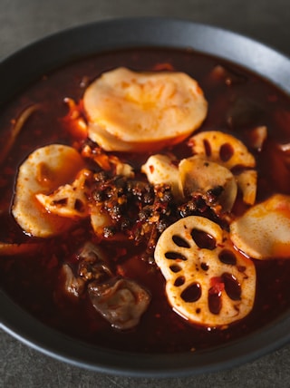 a bowl of soup with dumplings and meat