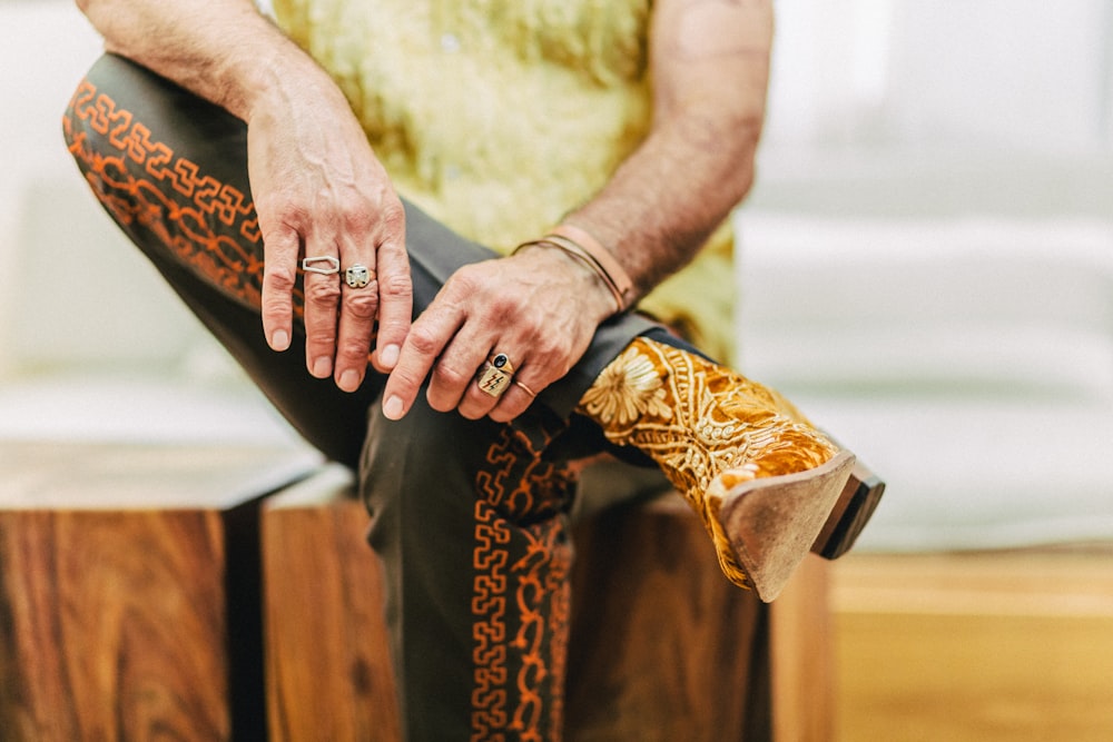 a man sitting on top of a wooden box