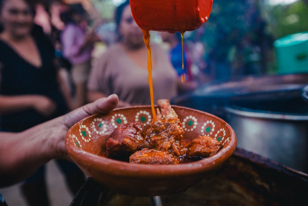 a bowl of food being poured into a bowl