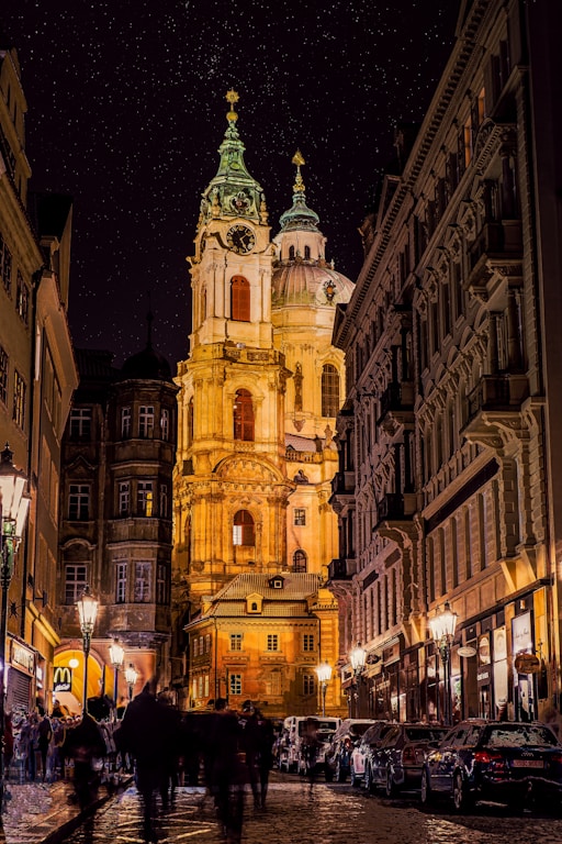 a group of people walking down a street next to tall buildings