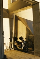 The garage entrance with a scooter parked outside, bathed in warm afternoon light.