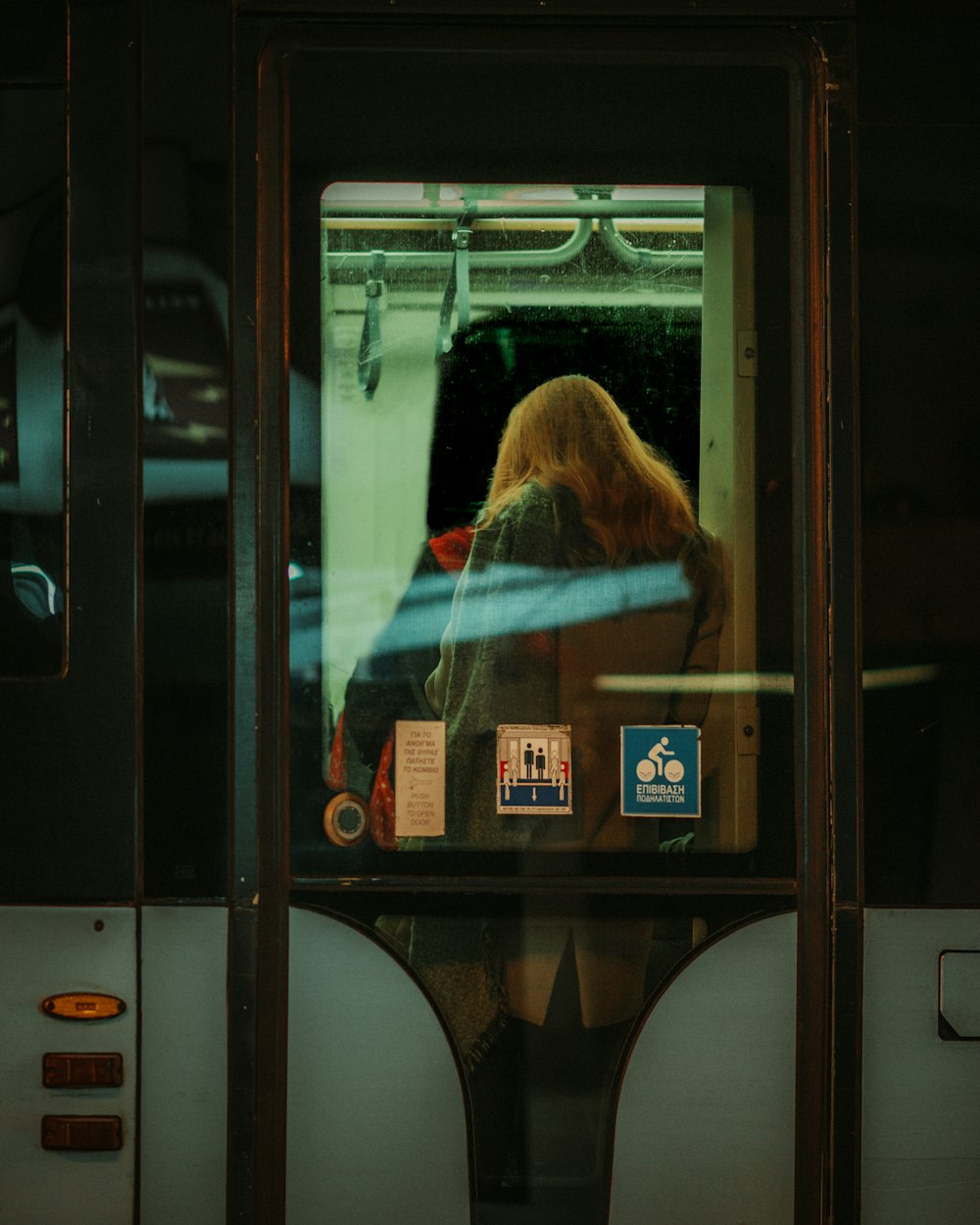 a woman sitting on a bus looking out the window