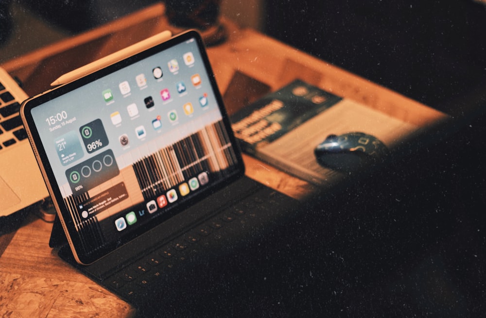 a laptop computer sitting on top of a wooden desk