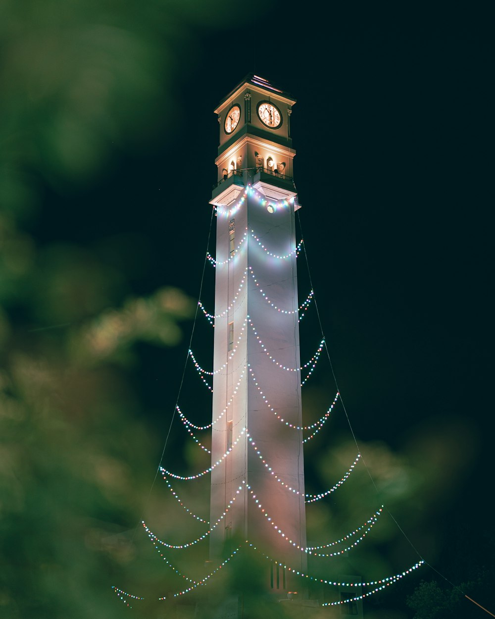 a tall clock tower with a clock on each of it's sides