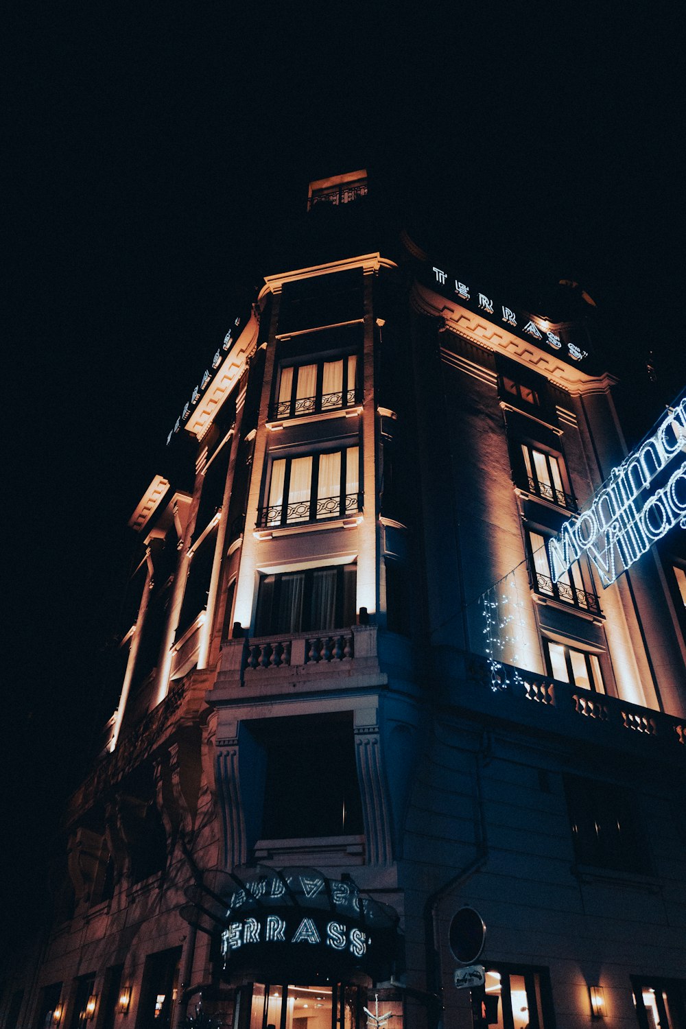 a building lit up at night with lights on it