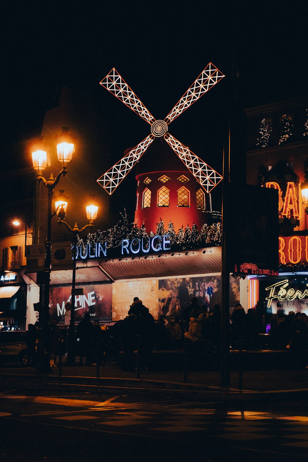 a building with a windmill on top of it at night