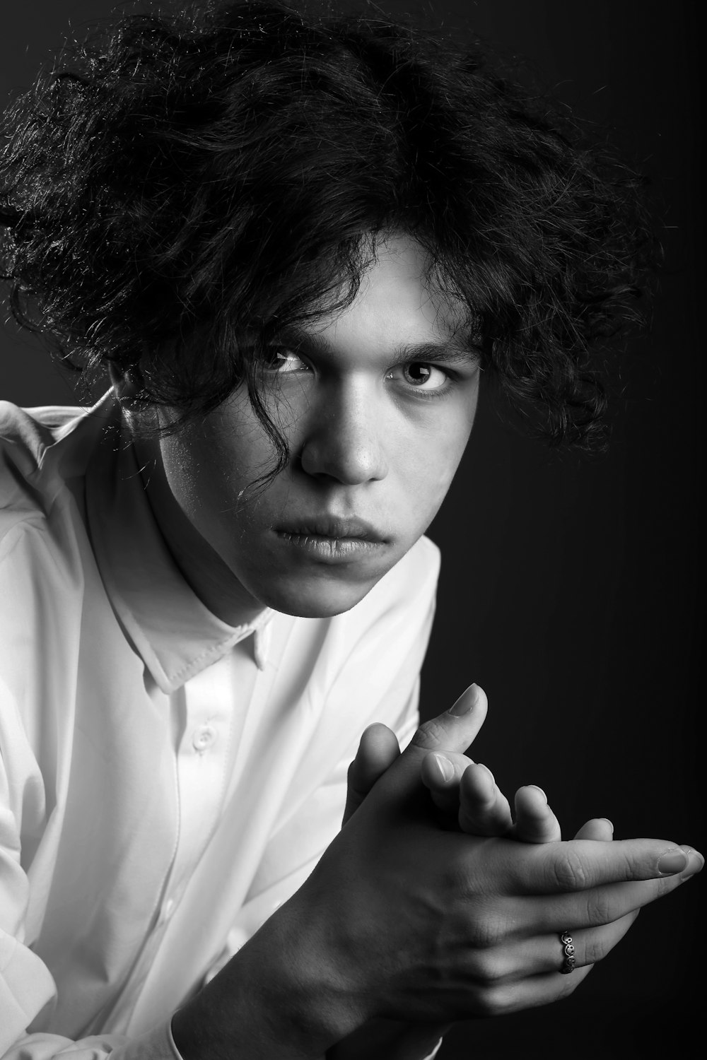 a black and white photo of a man with curly hair