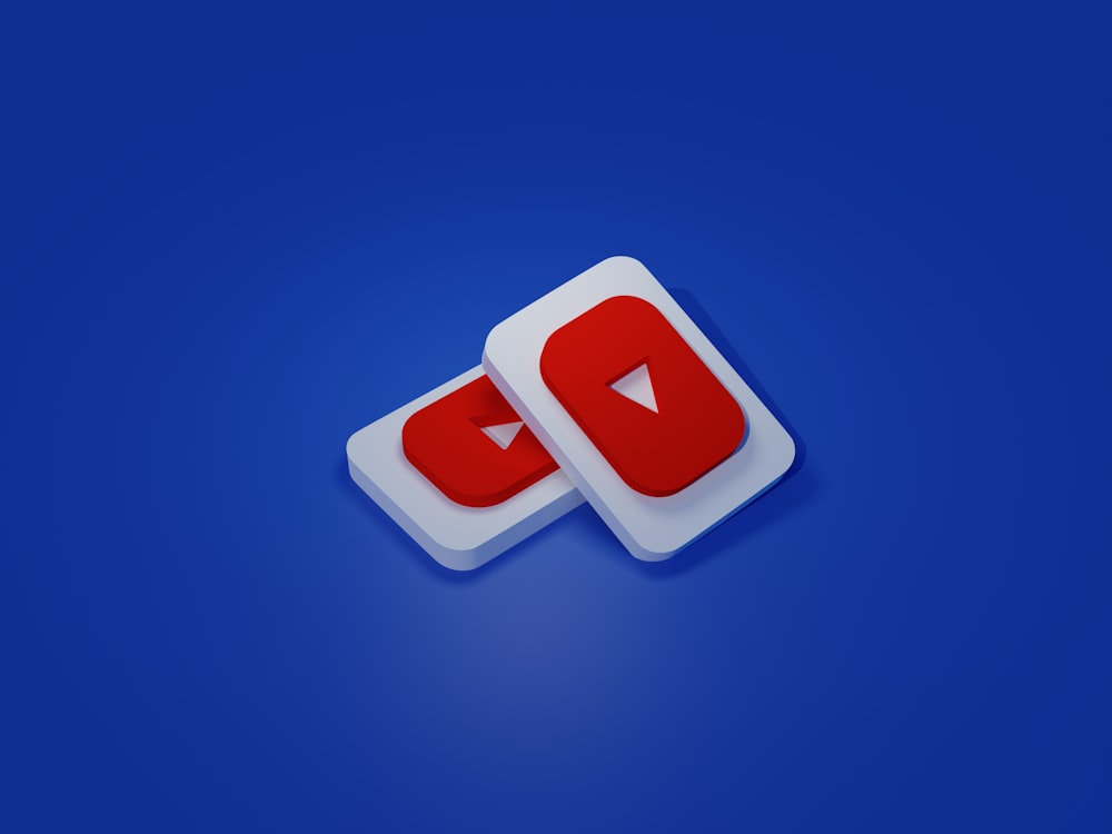 a pair of white and red play buttons on a blue background