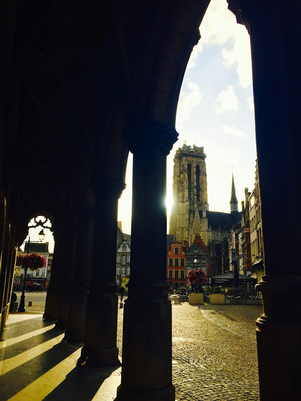 the sun is shining through the arches of a building