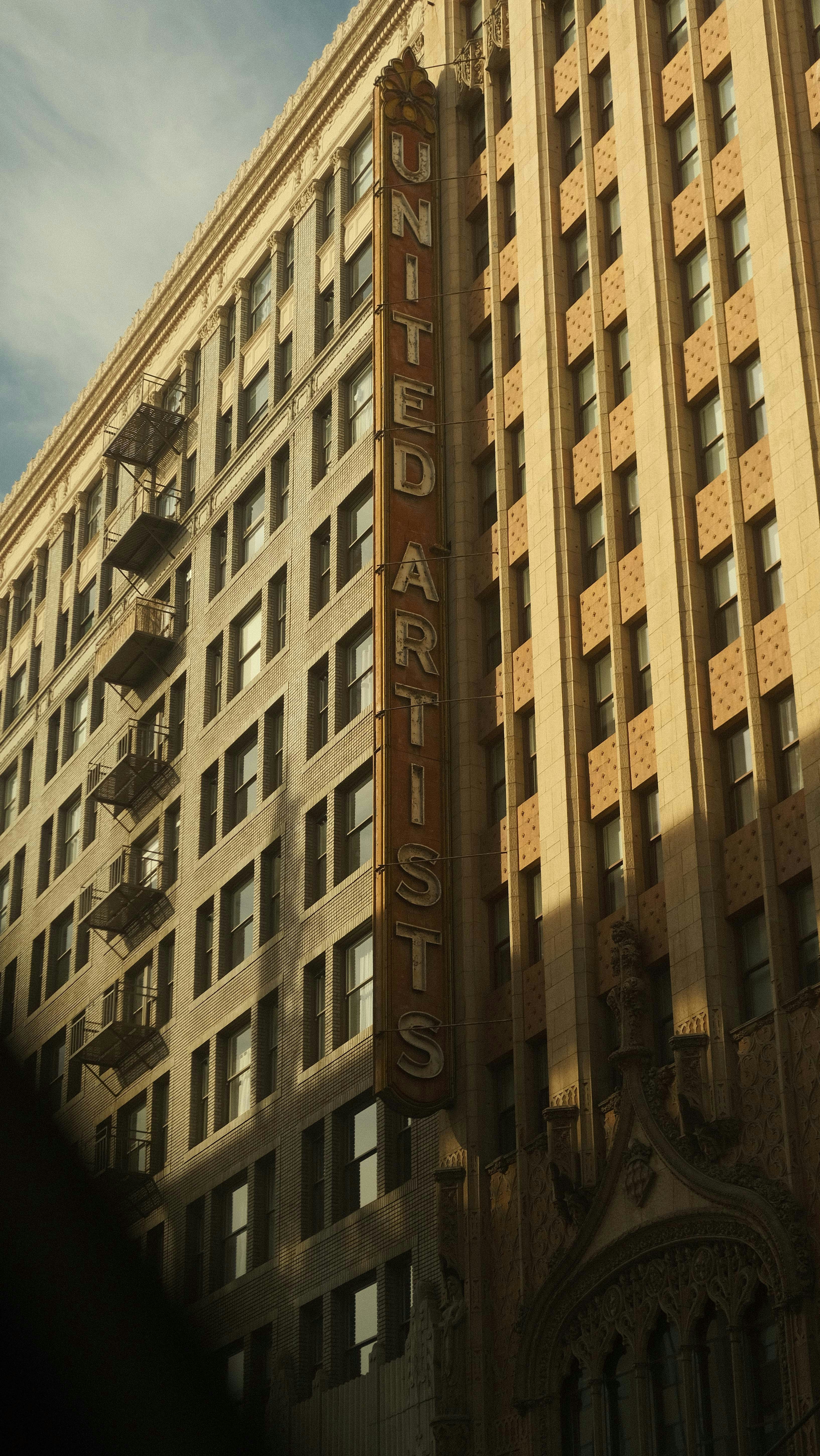 A tall building with a sign on the side of it photo – Free City Image ...